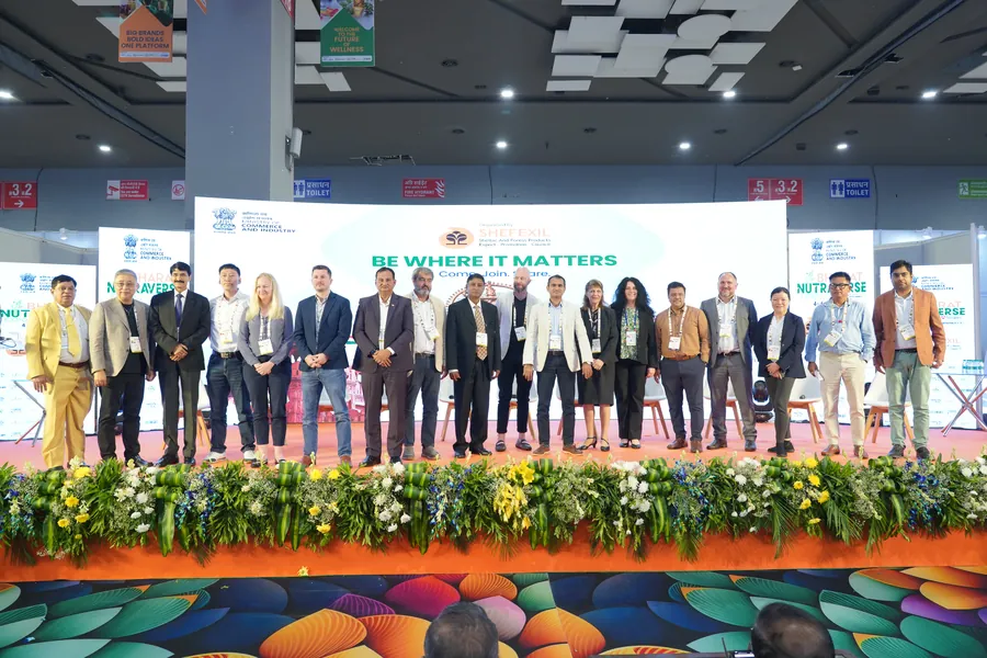 Group of people on stage for picture during event 